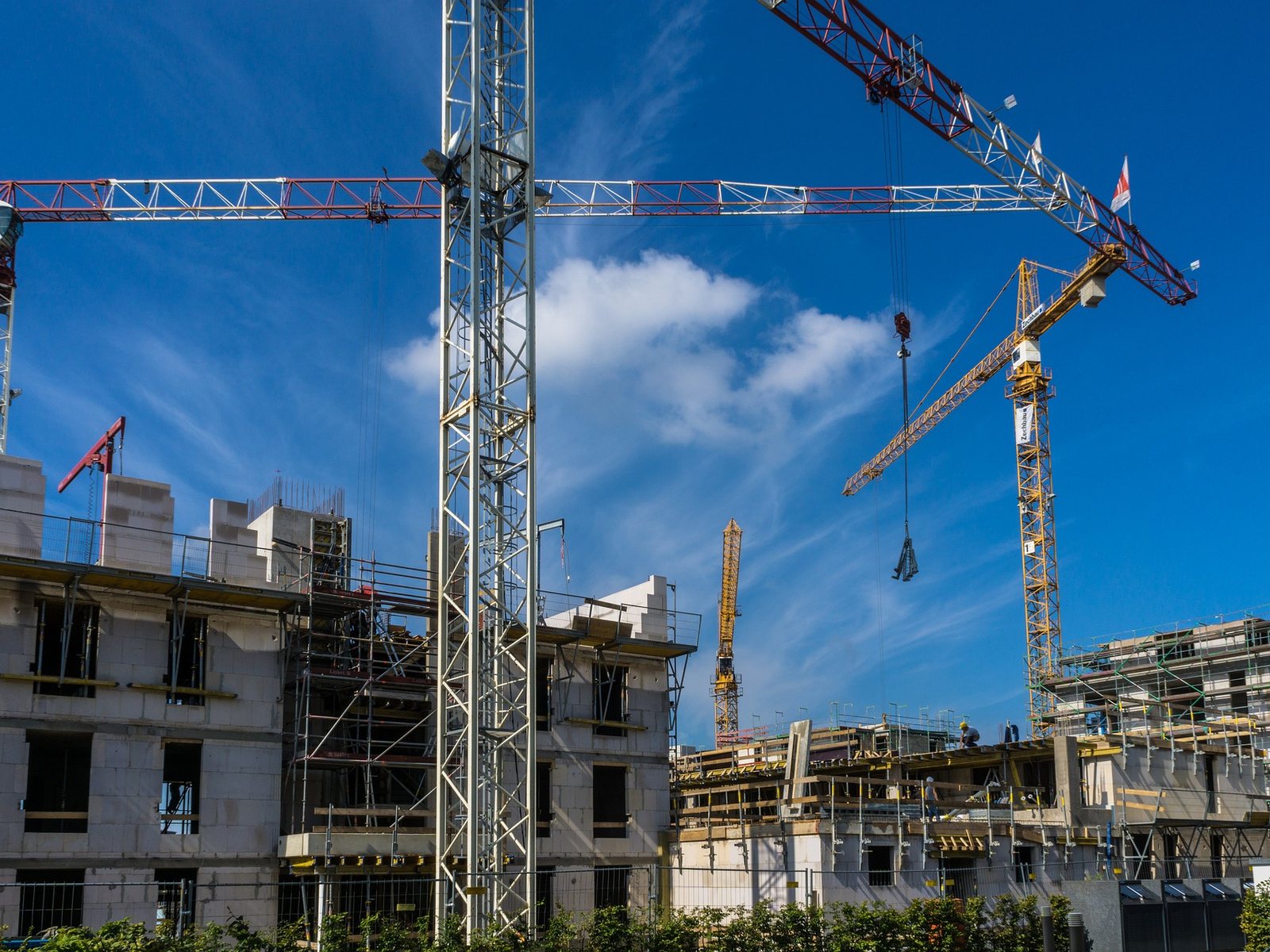 A construction site with two tower cranes